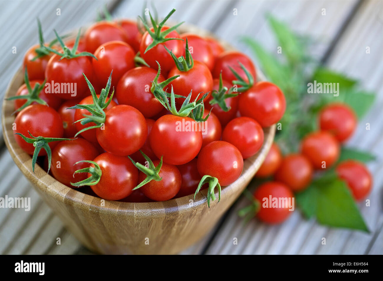 Cherry tomatoes in a wooden bowl Stock Photo - Alamy