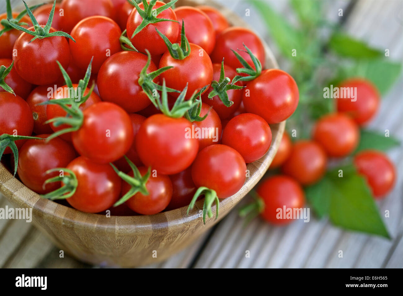 Cherry tomatoes in a wooden bowl Stock Photo - Alamy