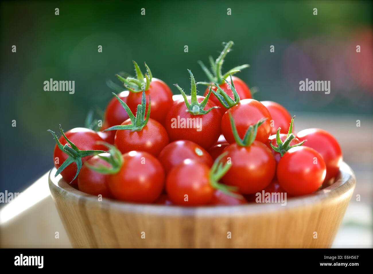 Cherry tomatoes in a wooden bowl Stock Photo - Alamy