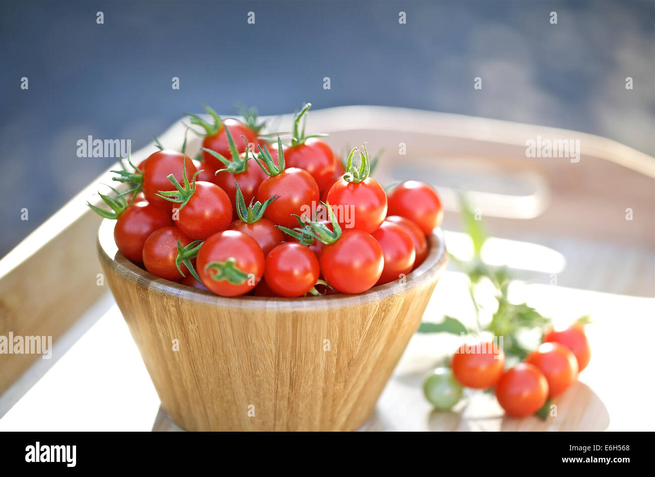 Cherry tomatoes in a wooden bowl Stock Photo - Alamy