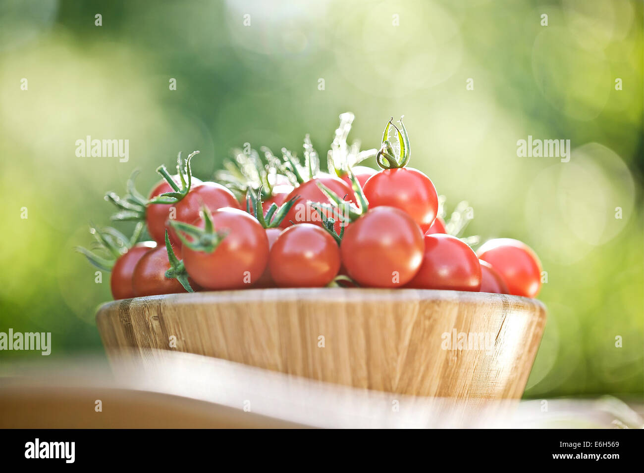 Cherry tomatoes in a wooden bowl Stock Photo - Alamy