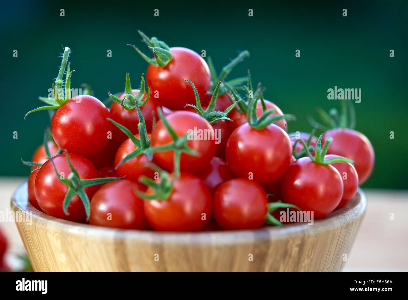 Cherry tomatoes in a wooden bowl Stock Photo - Alamy
