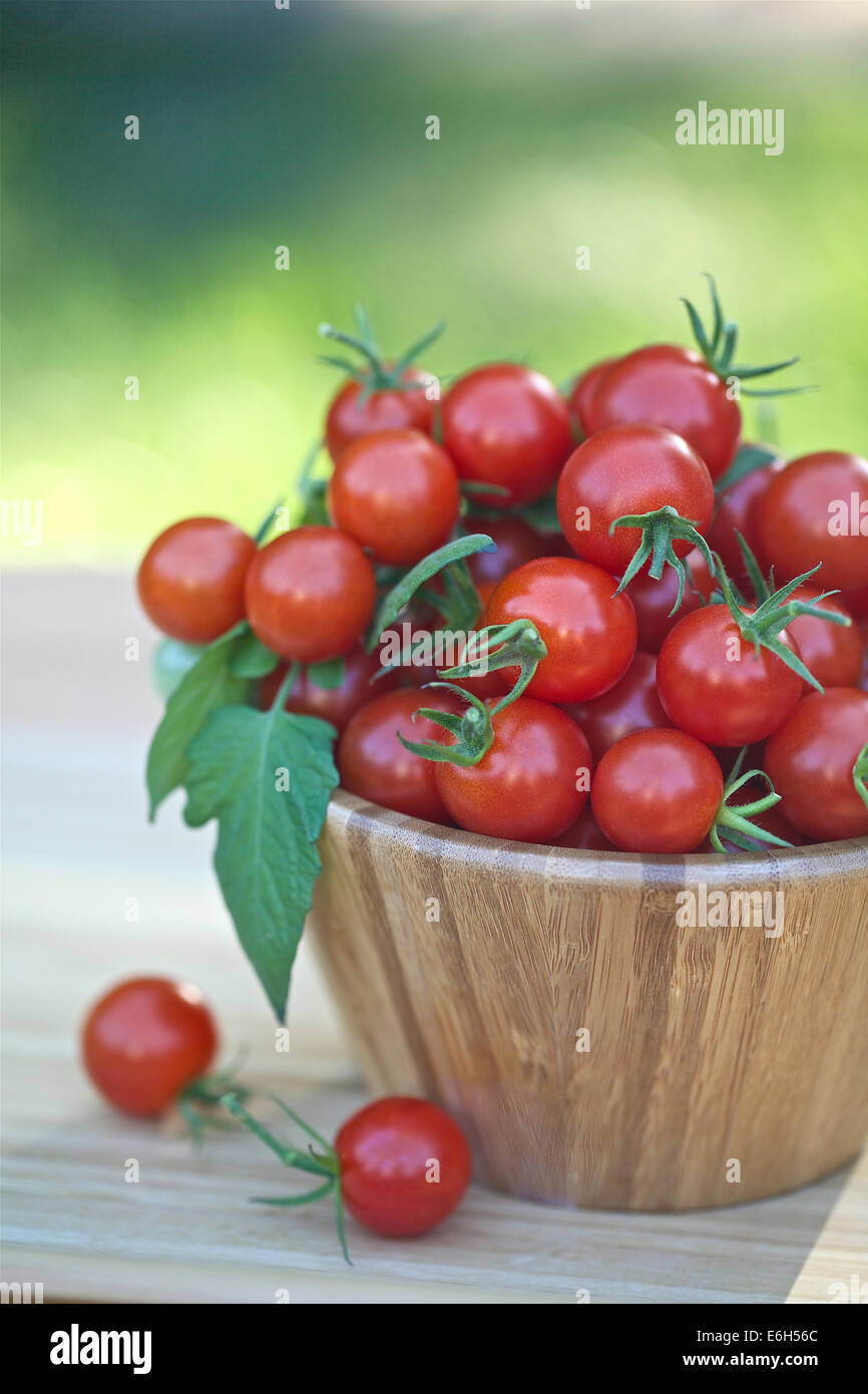 Cherry tomatoes in a wooden bowl Stock Photo - Alamy