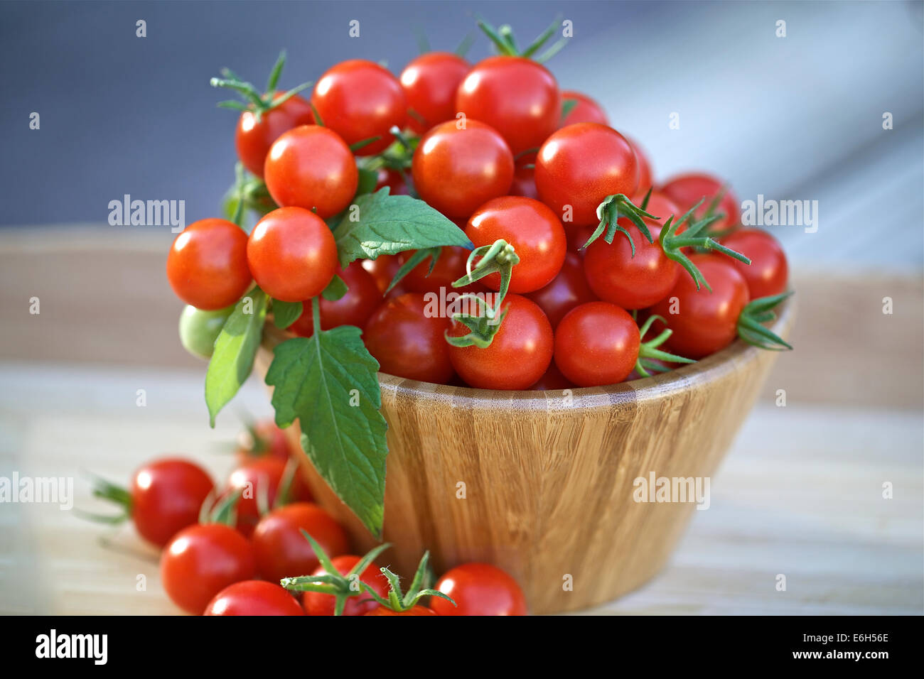Cherry tomatoes in a wooden bowl Stock Photo - Alamy