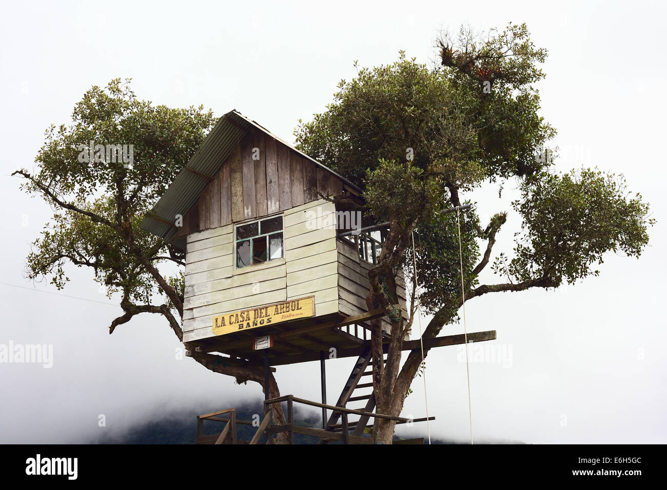 RUNTUN, ECUADOR - FEBRUARY 27, 2014: La Casa del Arbol (The Tree House) close to the small village of Runtun with clouds behind Stock Photo