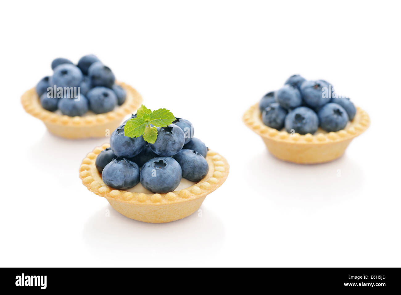 Delicious mini tart with fresh blueberries isolated on white Stock Photo