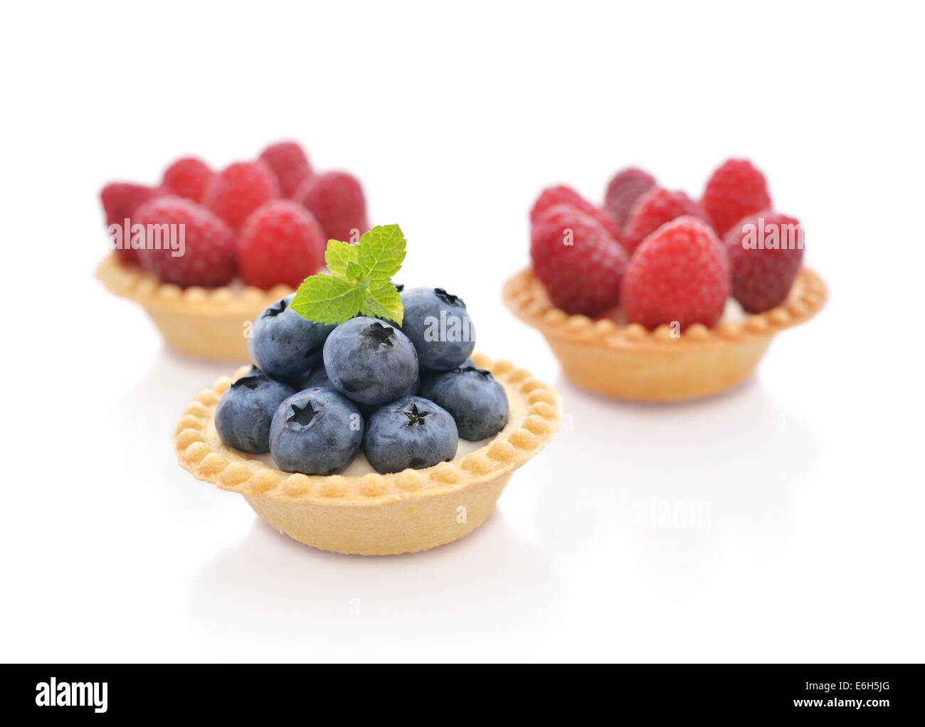 Delicious mini tart with fresh blueberry and raspberry isolated on white Stock Photo