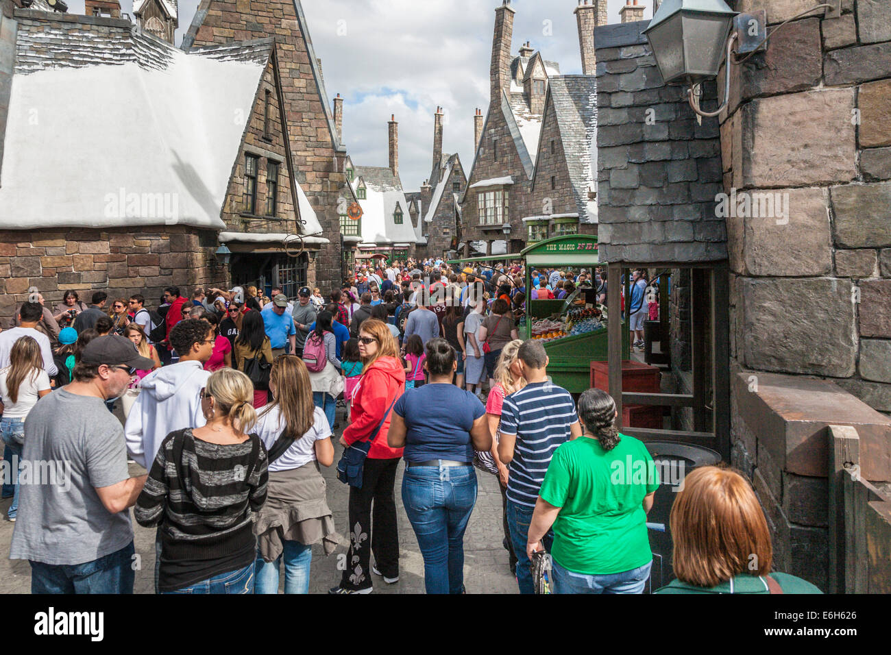 Theme park guests walk through Hogsmeade in The Wizarding World of Harry Potter at Universal Studios, Orlando, Florida Stock Photo