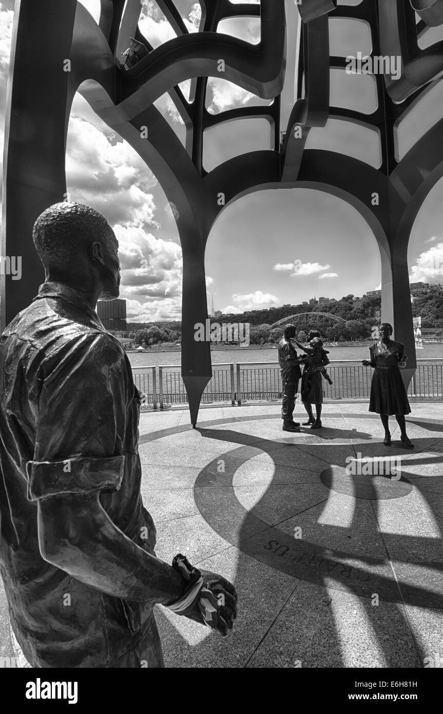 The Vietnam Veterans' Monument, on the North Shore of Pittsburgh, Pennsylvania, shows life-sized soldiers & families reuniting. Stock Photo
