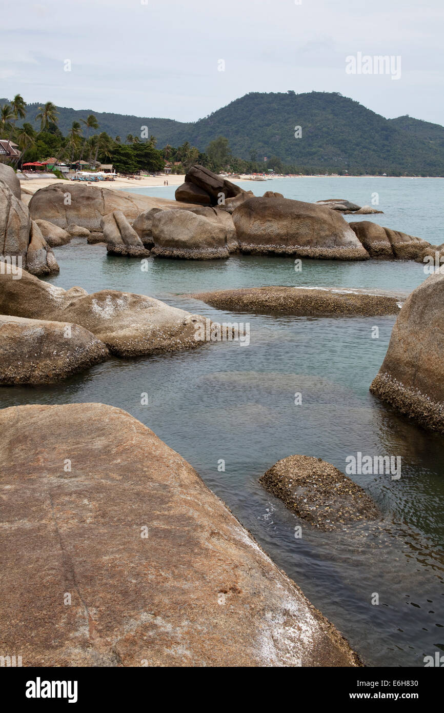 Group of rocks under a blue sky on the beach Stock Photo - Alamy