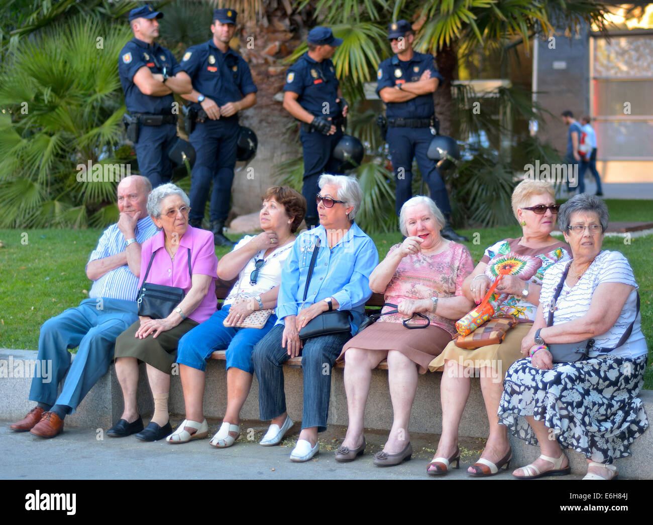 While younger people complain against anti-protest law ('Gag Law'), older sit and watch the demonstration, Madrid on July 11. 20 Stock Photo
