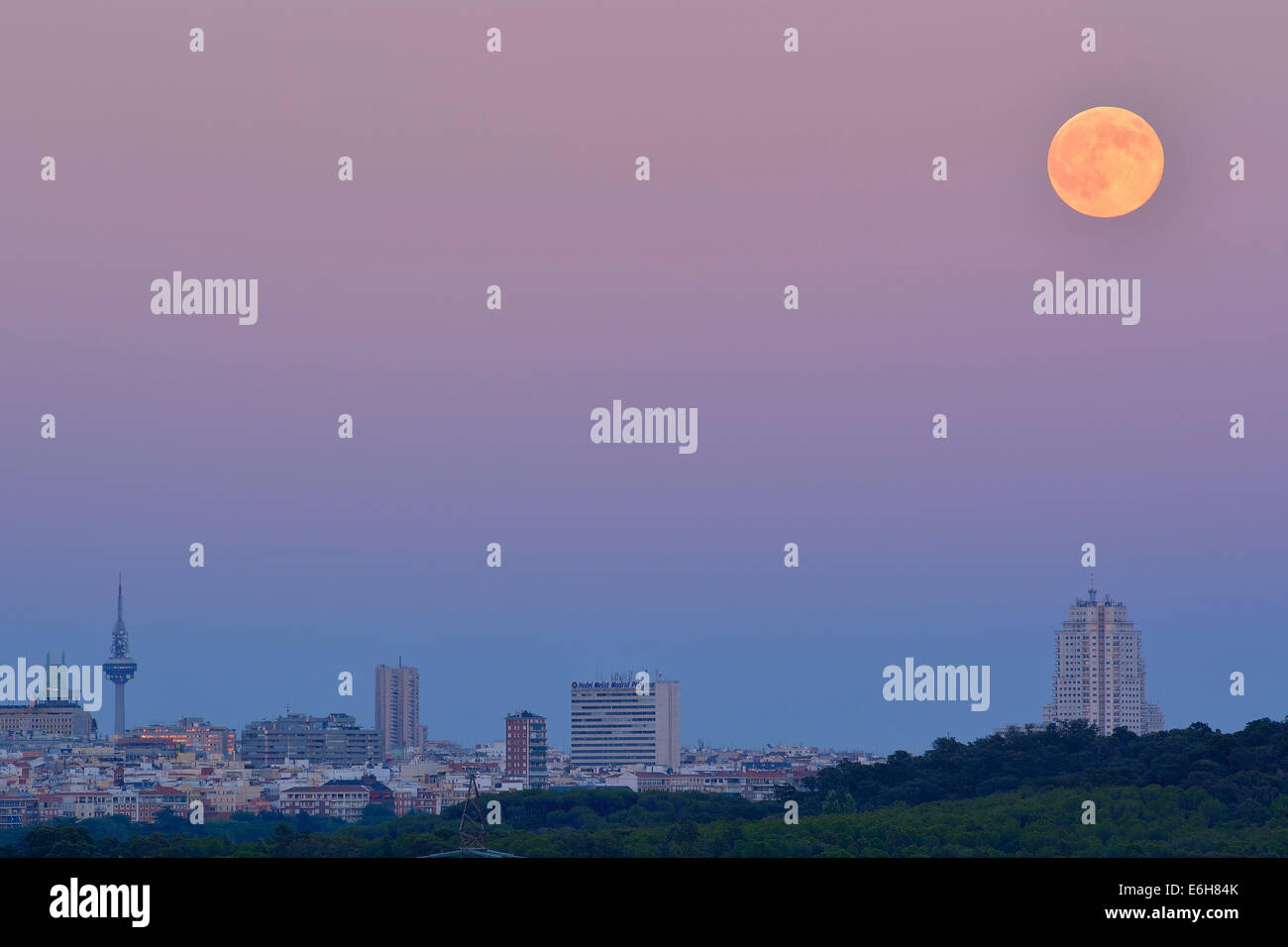 The full moon appears at its closest encounter with Earth for the year as it rises over the Madrid skyline, a phenomenon that is Stock Photo