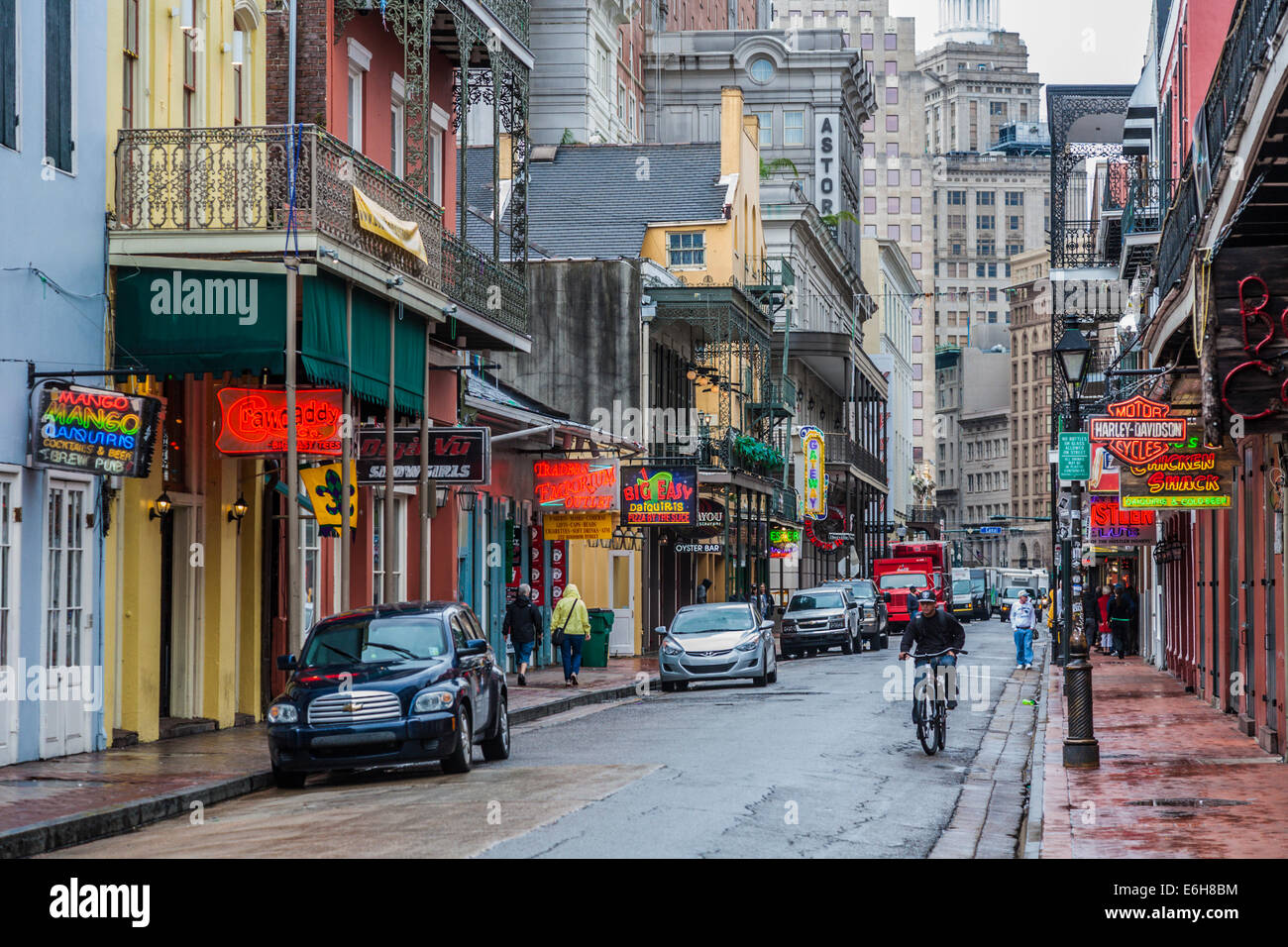 Neon signs contrast with old and newer architecture on a wet Bourbon Street in the French Quarter of New Orleans Stock Photo