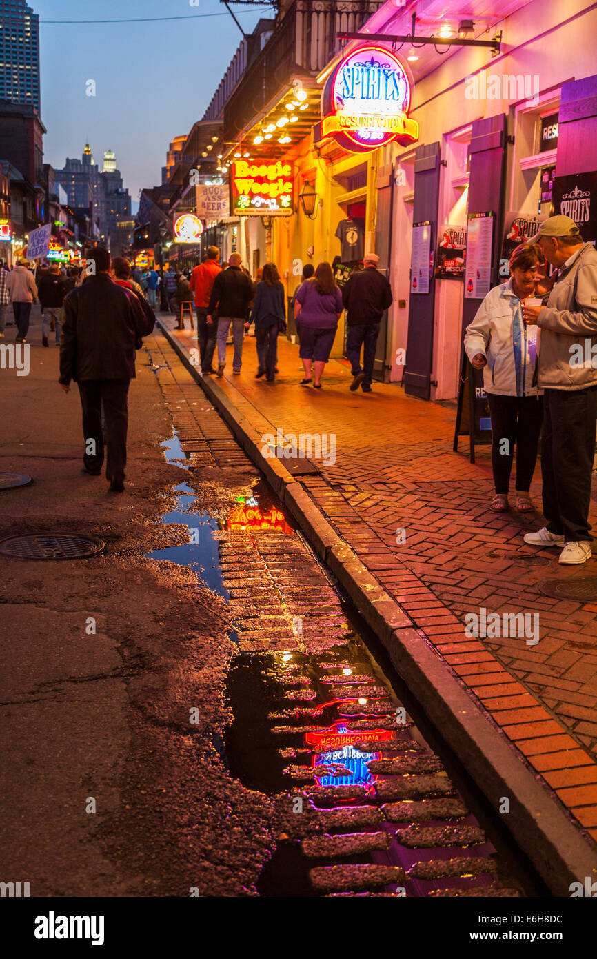 Neon signs reflected in the rain water on Bourbon Street at night in the French Quarter of New Orleans, Louisiana Stock Photo