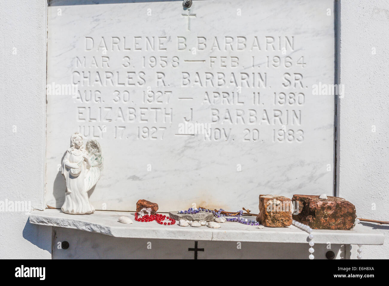 Sentimental trinkets and tributes left at an above ground grave in St. Louis Cemetery No. 1 in New Orleans, Louisiana Stock Photo