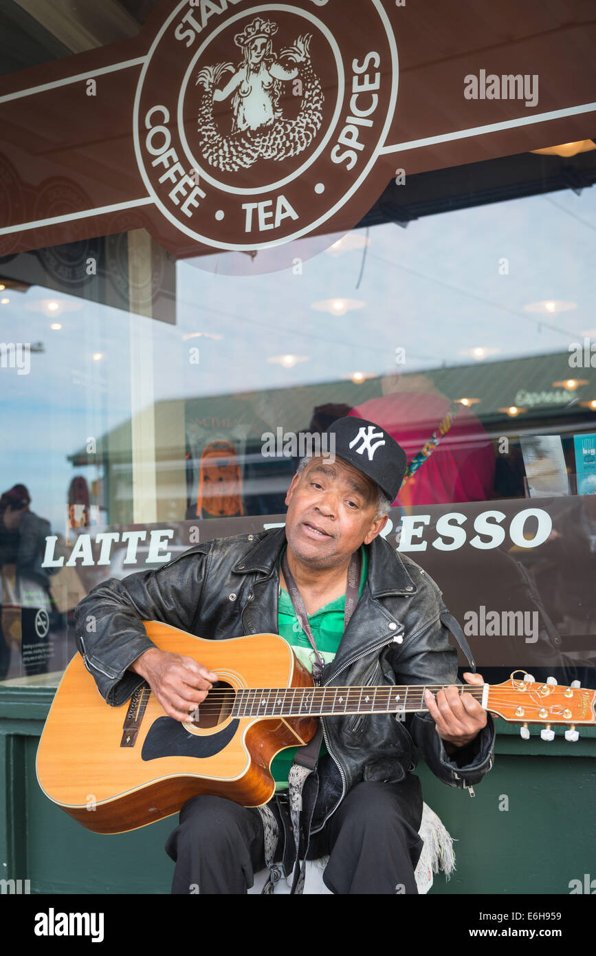 Busker playing guitar at Pike Place Market, Seattle. Stock Photo