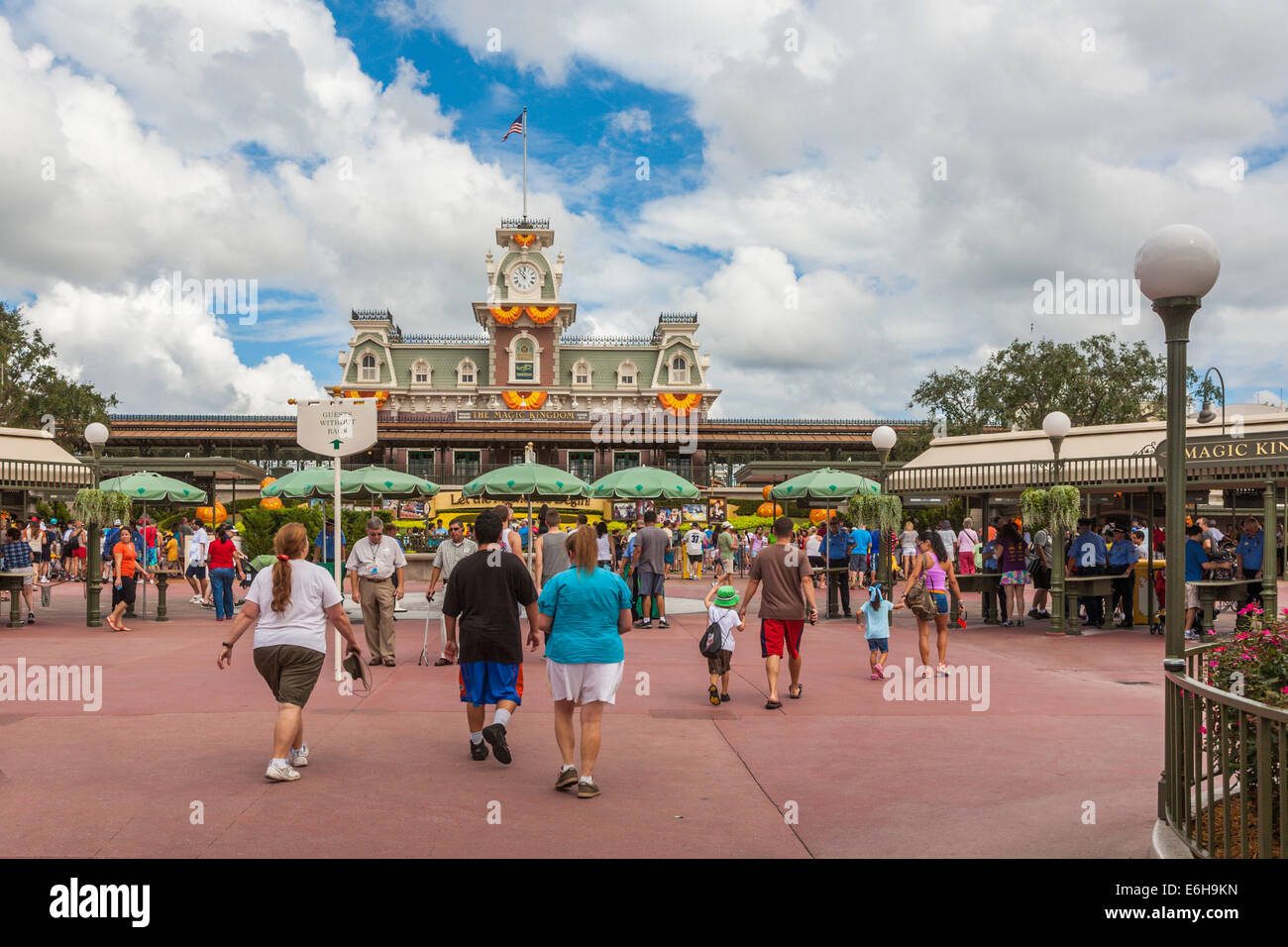 Park visitors walking toward the entrance to the Magic Kingdom at