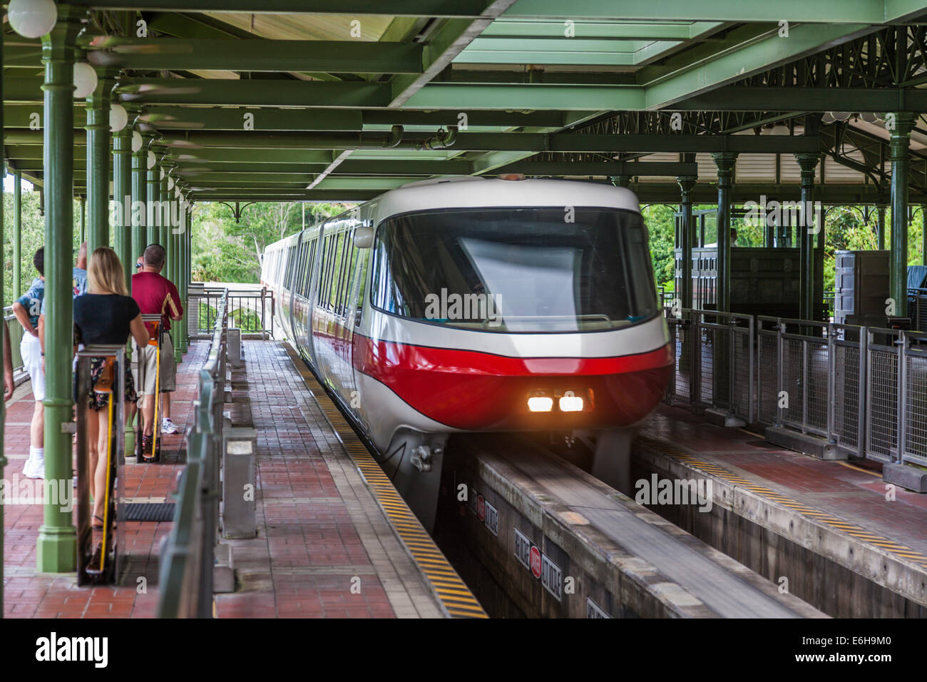 Theme park guests wait while Monorail pulls into station at the Magic Kingdom in Walt Disney World, Florida Stock Photo