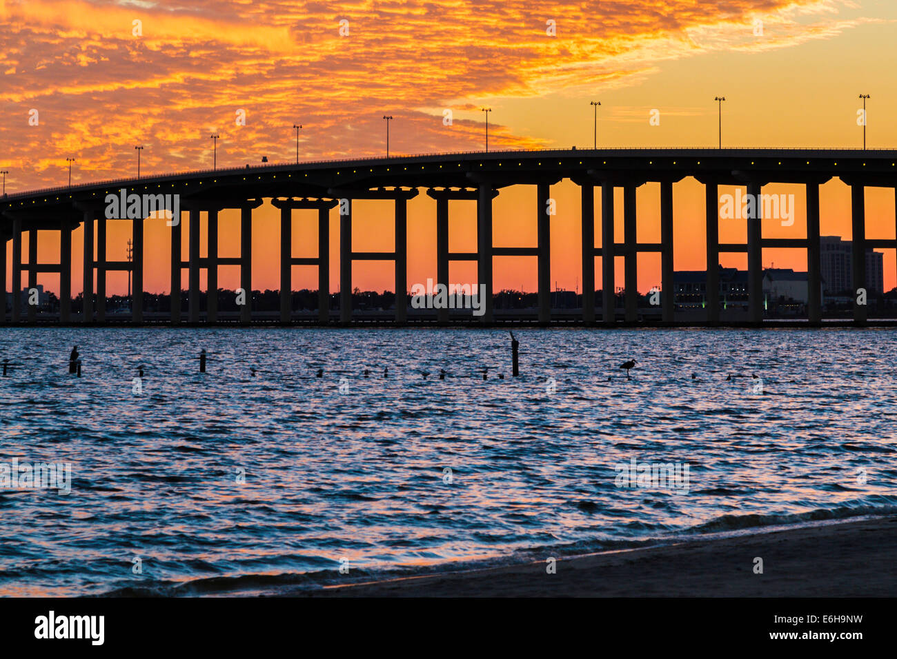 Dramatic sunset behind the BiloxiOcean Springs Back Bay bridge on the Mississippi Gulf Coast