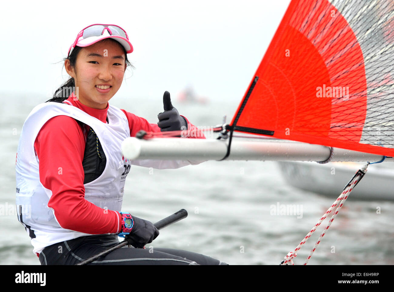 (SP)YOG-CHINA-NANJING-SAILING-WOMEN (140824) --Samantha Yom of Singapore celebrates after the Byte CII- Women?s One Person Dinghy Final Race of Sailing at the Nanjing 2014 Youth Olympic Games in Nanjing, capital of east China's Jiangsu Province, on August 24, 2014. Samantha Yom won the gold medal. (Xinhua/Yue Yuewei)(jyt) Stock Photo