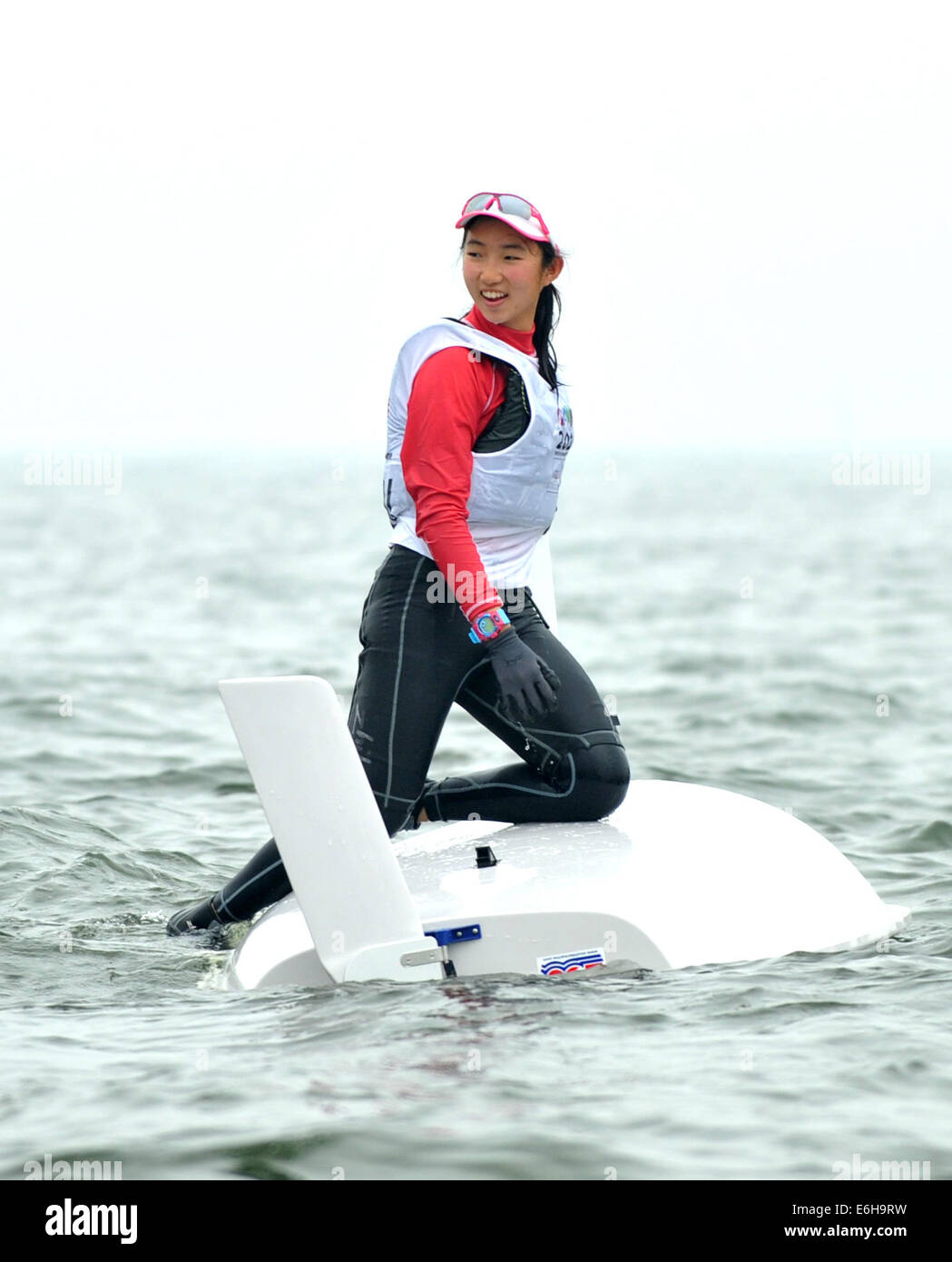 (SP)YOG-CHINA-NANJING-SAILING-WOMEN (140824) -- Samantha Yom of Singapore celebrates after the Byte CII- Women?s One Person Dinghy Final Race of Sailing at the Nanjing 2014 Youth Olympic Games in Nanjing, capital of east China's Jiangsu Province, on August 24, 2014. Samantha Yom won the gold medal. (Xinhua/Yue Yuewei)(jyt) Stock Photo