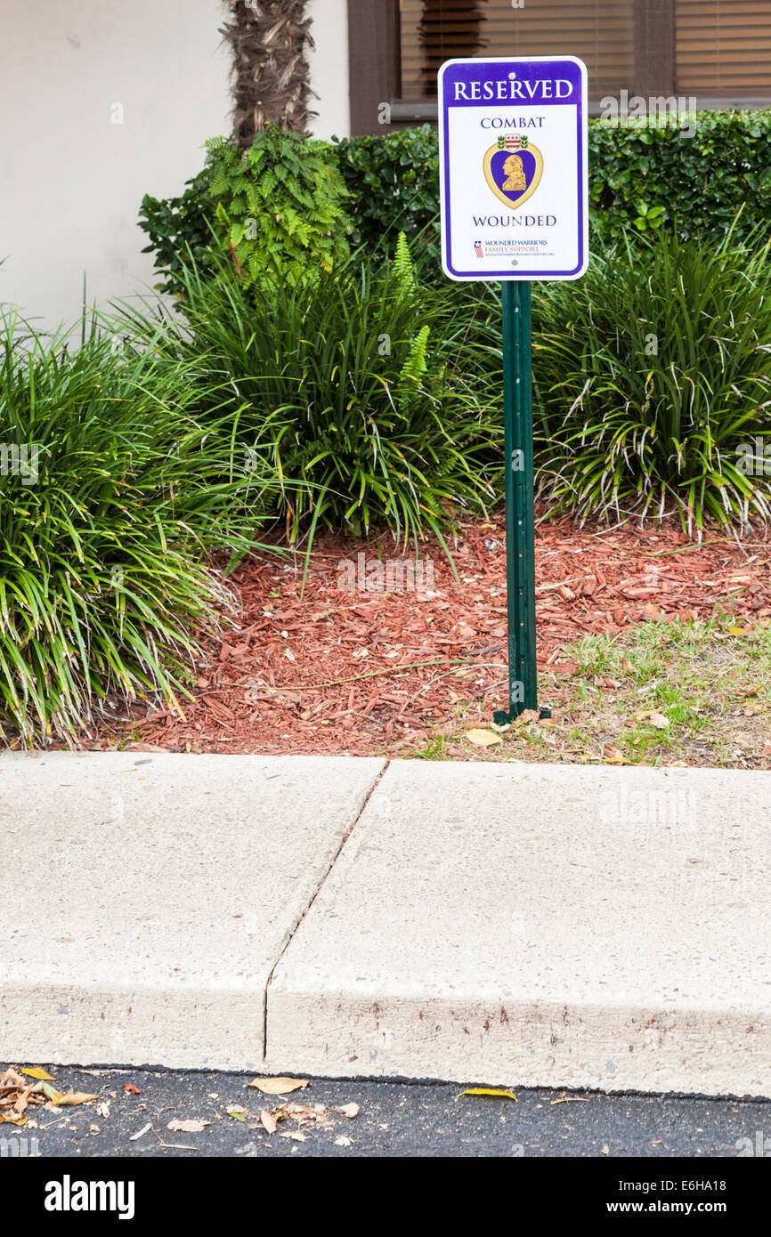 Sign marks parking space reserved for Combat Wounded Veterans at restaurant in Florida Stock Photo