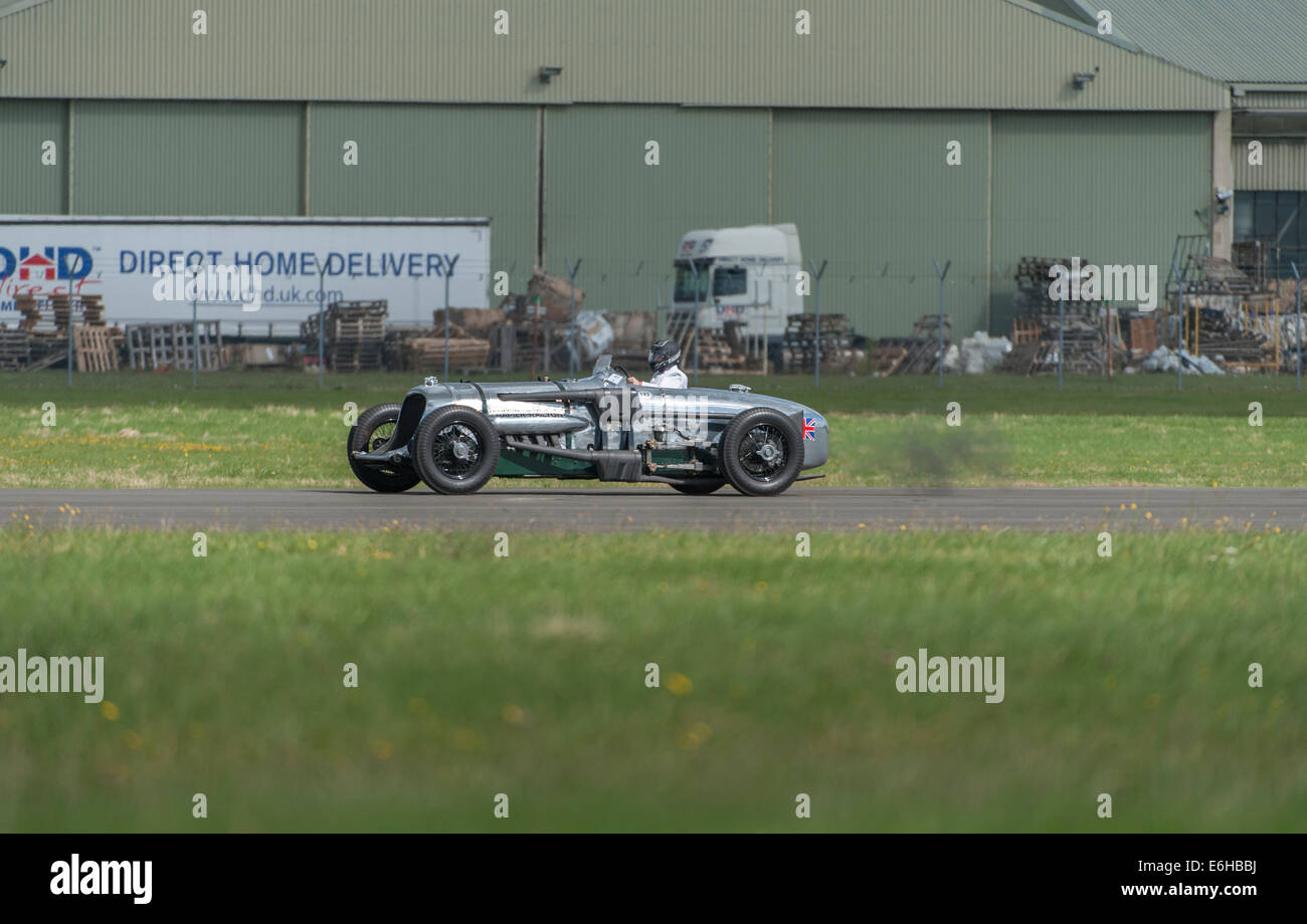 Dunsfold Aerodrome, Surrey UK. Saturday 23rd August 2014. The Napier-Railton on a fast run down the runway at the 10th Dunsfold Wings and Wheels. The fastest car ever around the Brooklands Outer Circuit (John Cobb’s lap at an average speed of 143.44mph in 1935 stands in perpetuity). The car has a 24 litre, 12 cylinder Napier Lion aircraft engine. Credit:  Malcolm Park editorial/Alamy Live News. Stock Photo