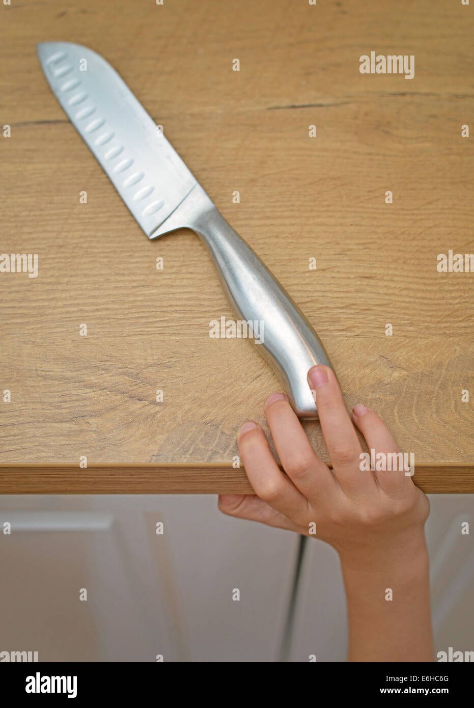 Dangerous situation in the kitchen. Child is trying to get a kitchen