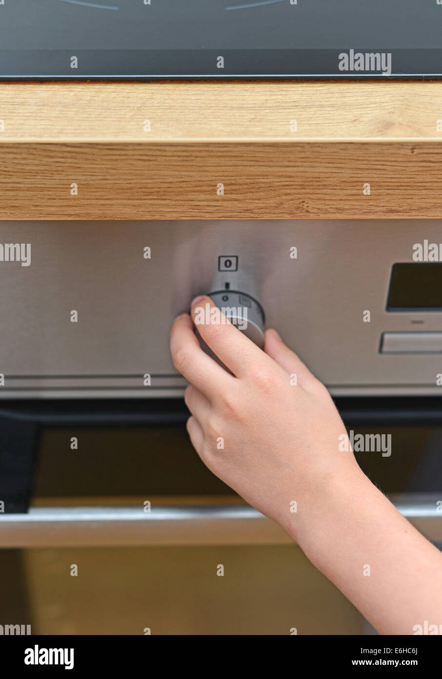 Dangerous situation in the kitchen. Child playing with electric oven
