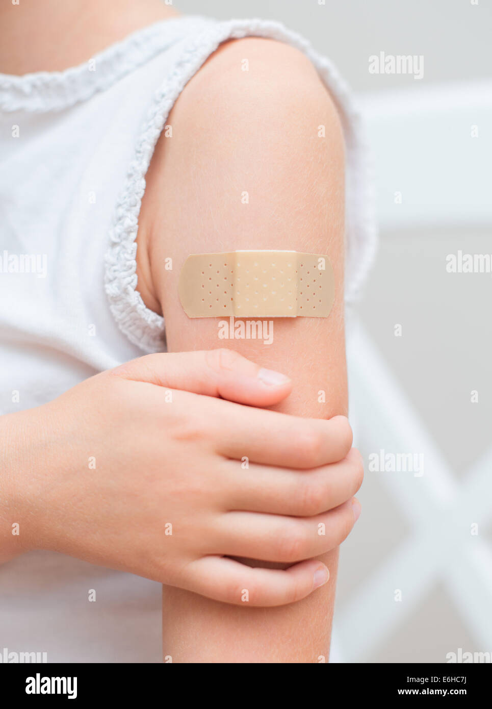 Child arm with an adhesive bandage. Stock Photo