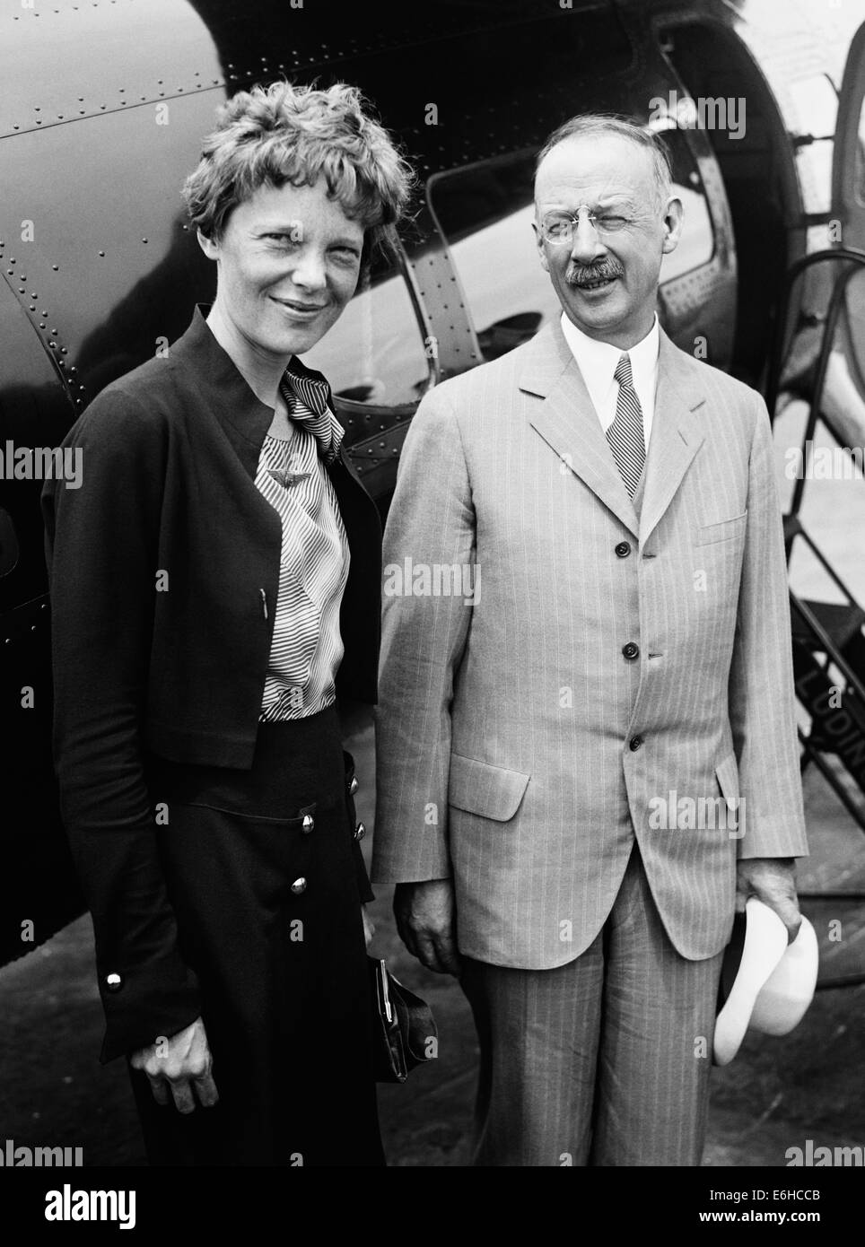 Vintage photo of American aviation pioneer and author Amelia Earhart (1897 – declared dead 1939) – Earhart and her navigator Fred Noonan famously vanished in 1937 while she was trying to become the first female to complete a circumnavigational flight of the globe. Earhart is pictured in 1932 with Gilbert Grosvenor, Editor of National Geographic magazine and President of the National Geographic Society. Stock Photo