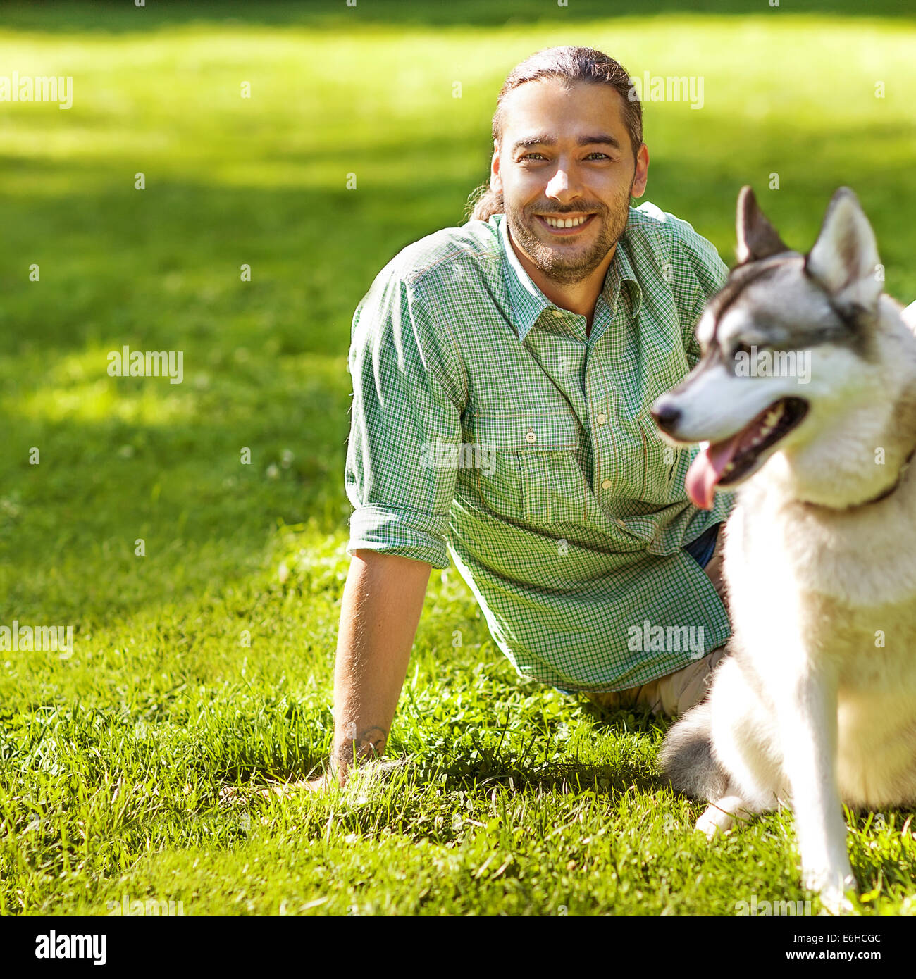 Man and Husky dog walk in the park Stock Photo - Alamy