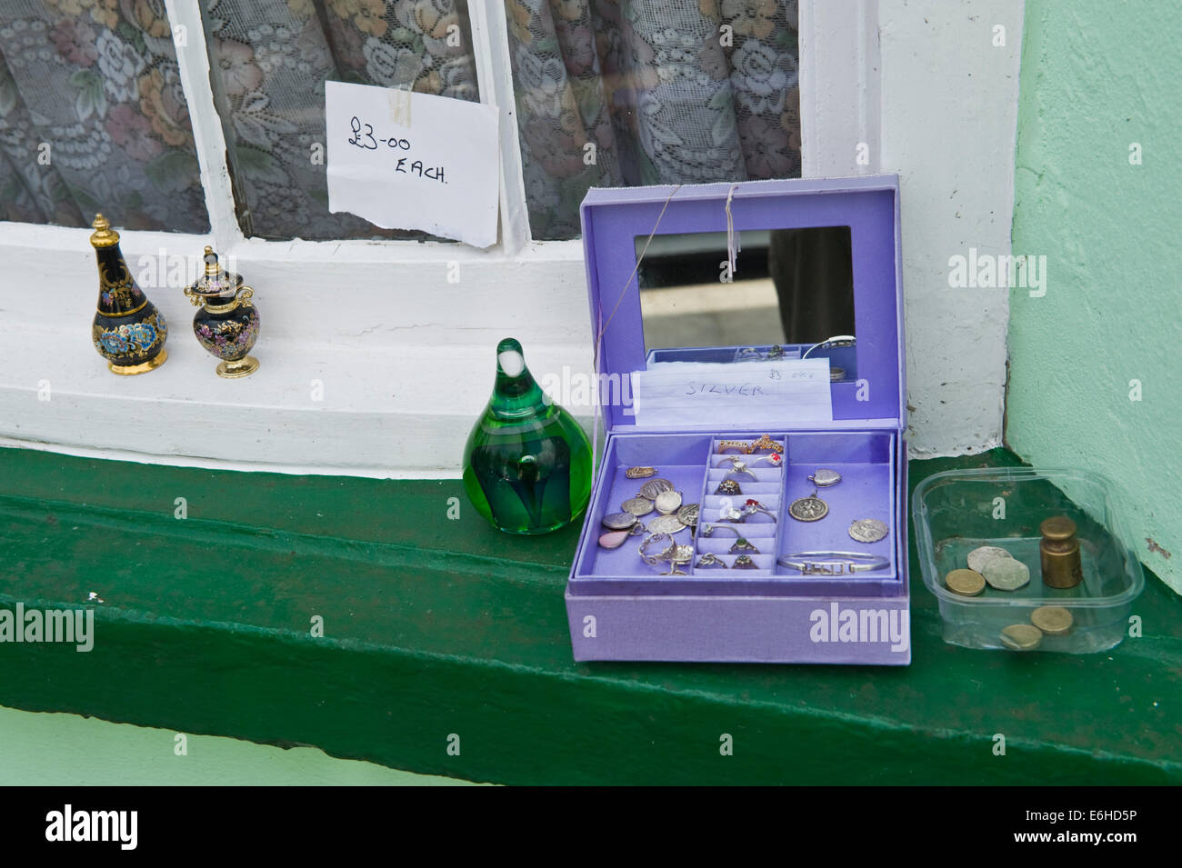 Bric a brac for sale on window sill of period terraced house in Brecon Powys Wales UK Stock Photo