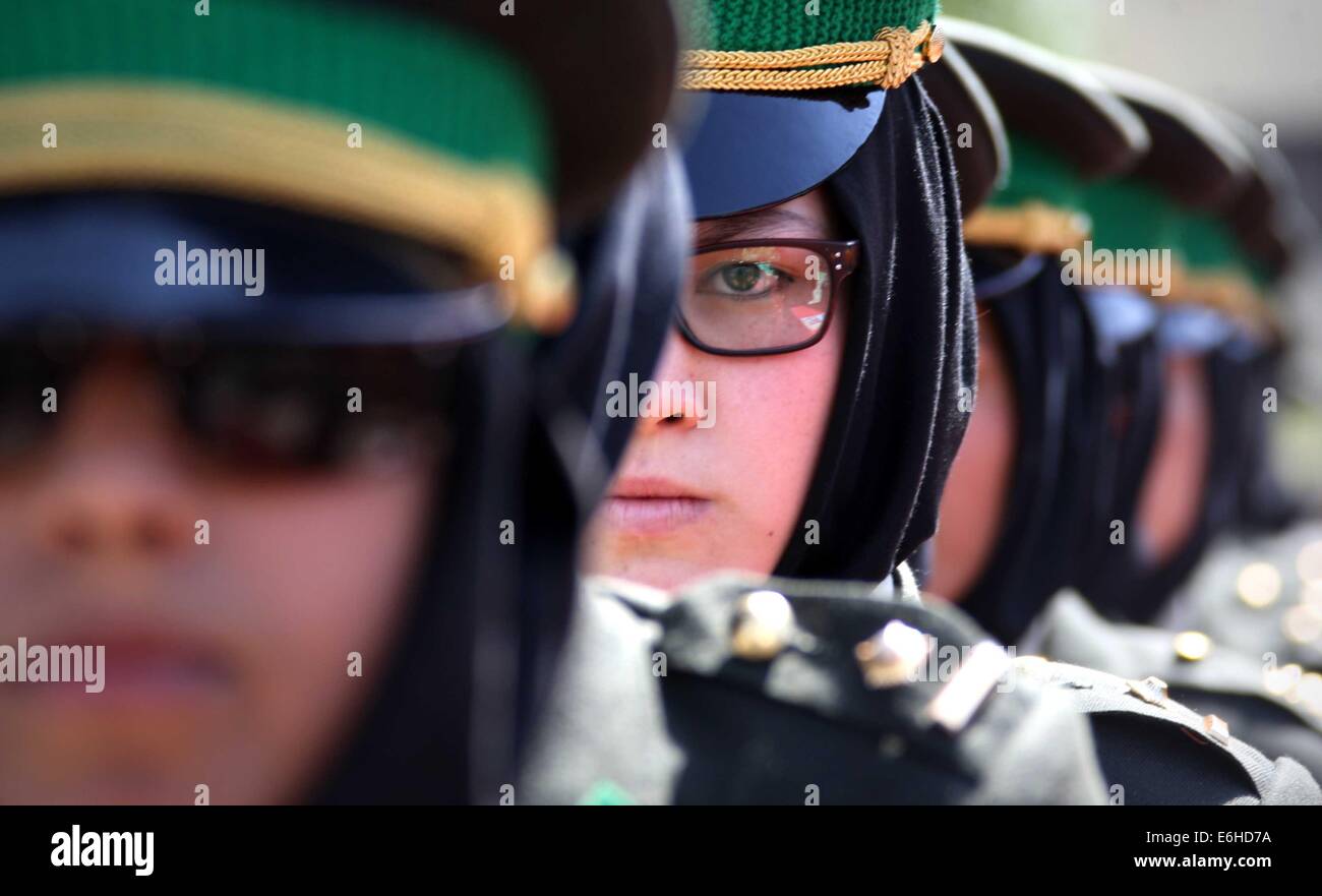 Kabul, Afghanistan. 24th Aug, 2014. Newly-graduated female Afghan National Army (ANA) officers stand during the graduation ceremony in Kabul, Afghanistan on Aug. 24, 2014. A total of 30 female army officers graduated from Kabul Military Training Center (KMTC) on Sunday and commissioned to ANA, General Aminullah Paktiani commander of KMTC said. Credit:  Ahmad Massoud/Xinhua/Alamy Live News Stock Photo