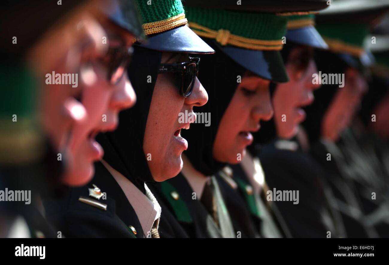 Kabul, Afghanistan. 24th Aug, 2014. Newly-graduated female Afghan National Army (ANA) officers take oath during their graduation ceremony in Kabul, Afghanistan on Aug. 24, 2014. A total of 30 female army officers graduated from Kabul Military Training Center (KMTC) on Sunday and commissioned to ANA, General Aminullah Paktiani commander of KMTC said. Credit:  Ahmad Massoud/Xinhua/Alamy Live News Stock Photo