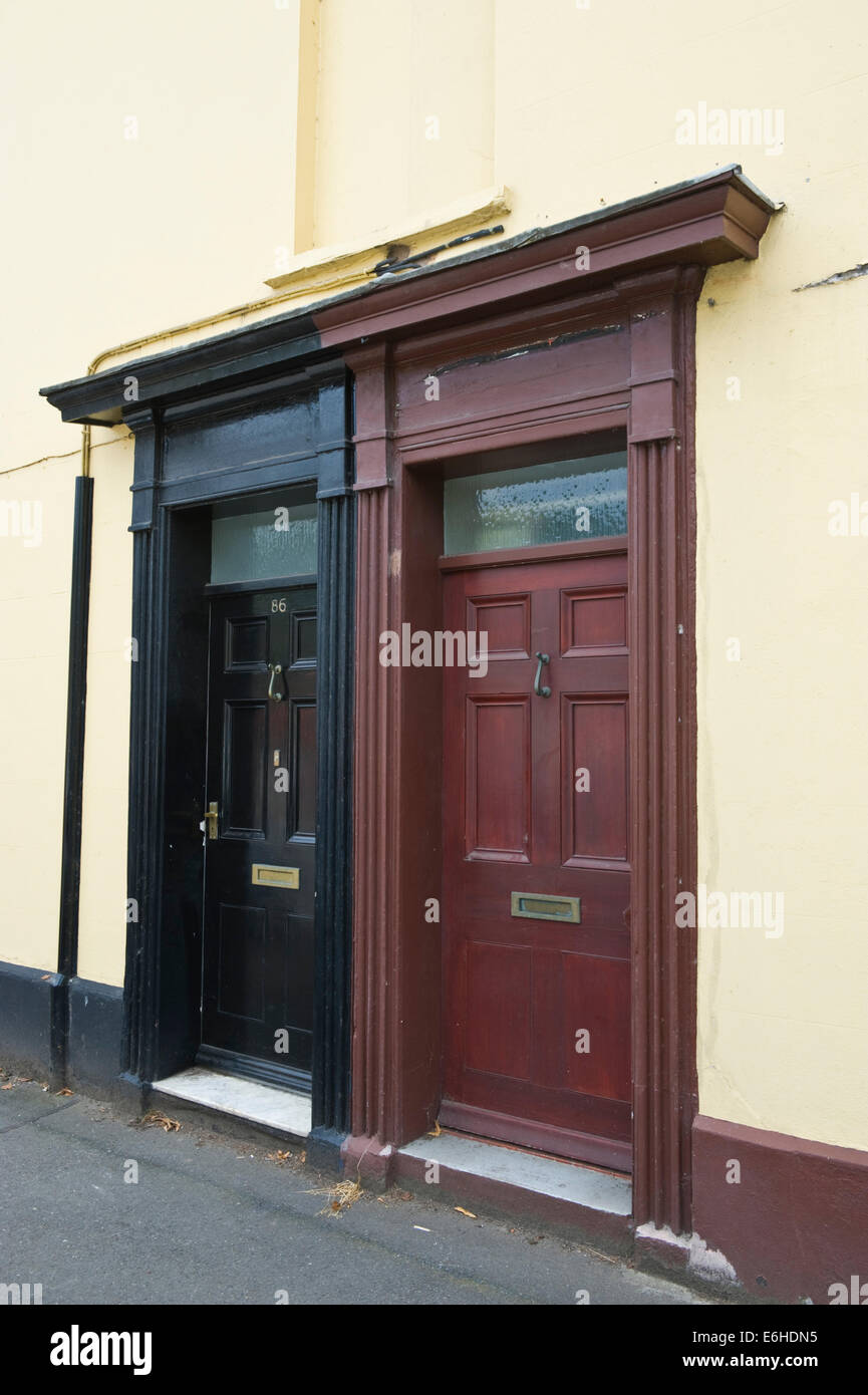 Black & brown wooden front doors of terraced houses in Brecon Powys