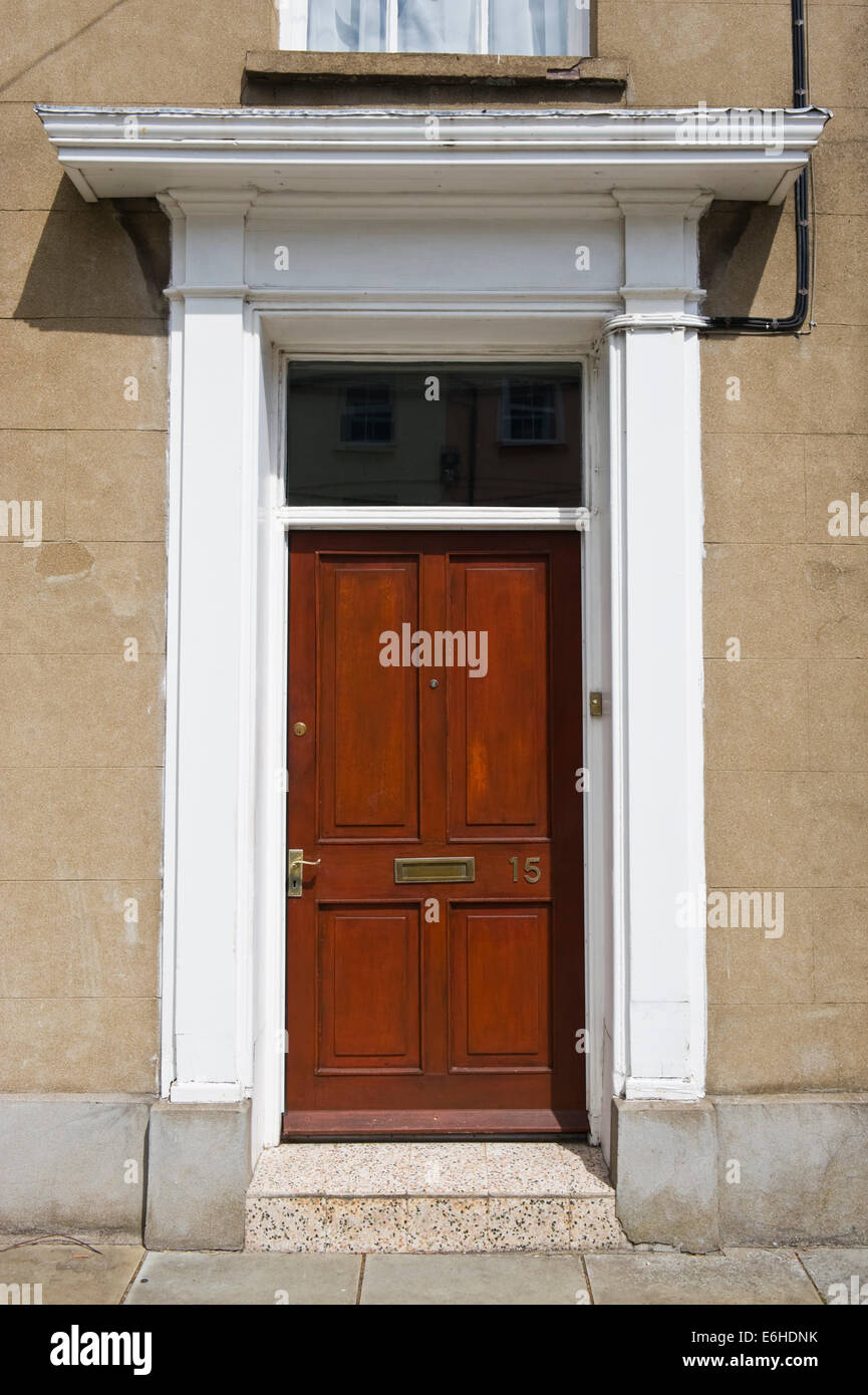Brown number 15 wooden front door with white surround of terraced house in Brecon Powys Wales UK Stock Photo