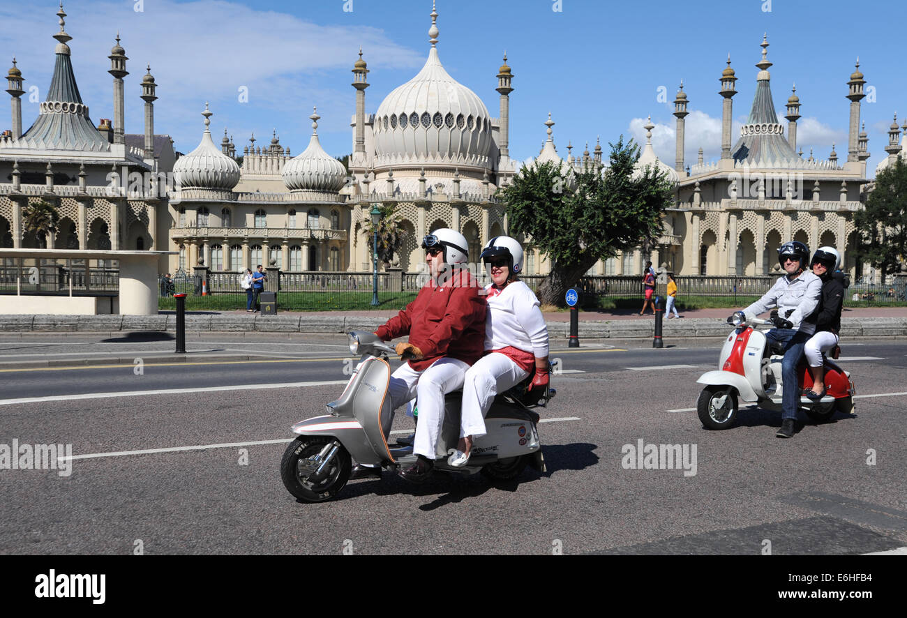 Mods drive past Brighton's Royal Pavilion as they arrive for the annual Mods Weekender event for August bank holiday Stock Photo