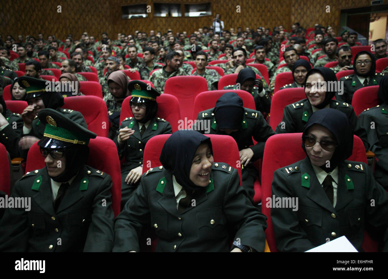 Kabul, Afghanistan. 24th Aug, 2014. Newly-graduated female Afghan National Army (ANA) officers attend the graduation ceremony in Kabul, Afghanistan on Aug. 24, 2014. A total of 30 female army officers graduated from Kabul Military Training Center (KMTC) on Sunday and commissioned to ANA, General Aminullah Paktiani commander of KMTC said. Credit:  Ahmad Massoud/Xinhua/Alamy Live News Stock Photo