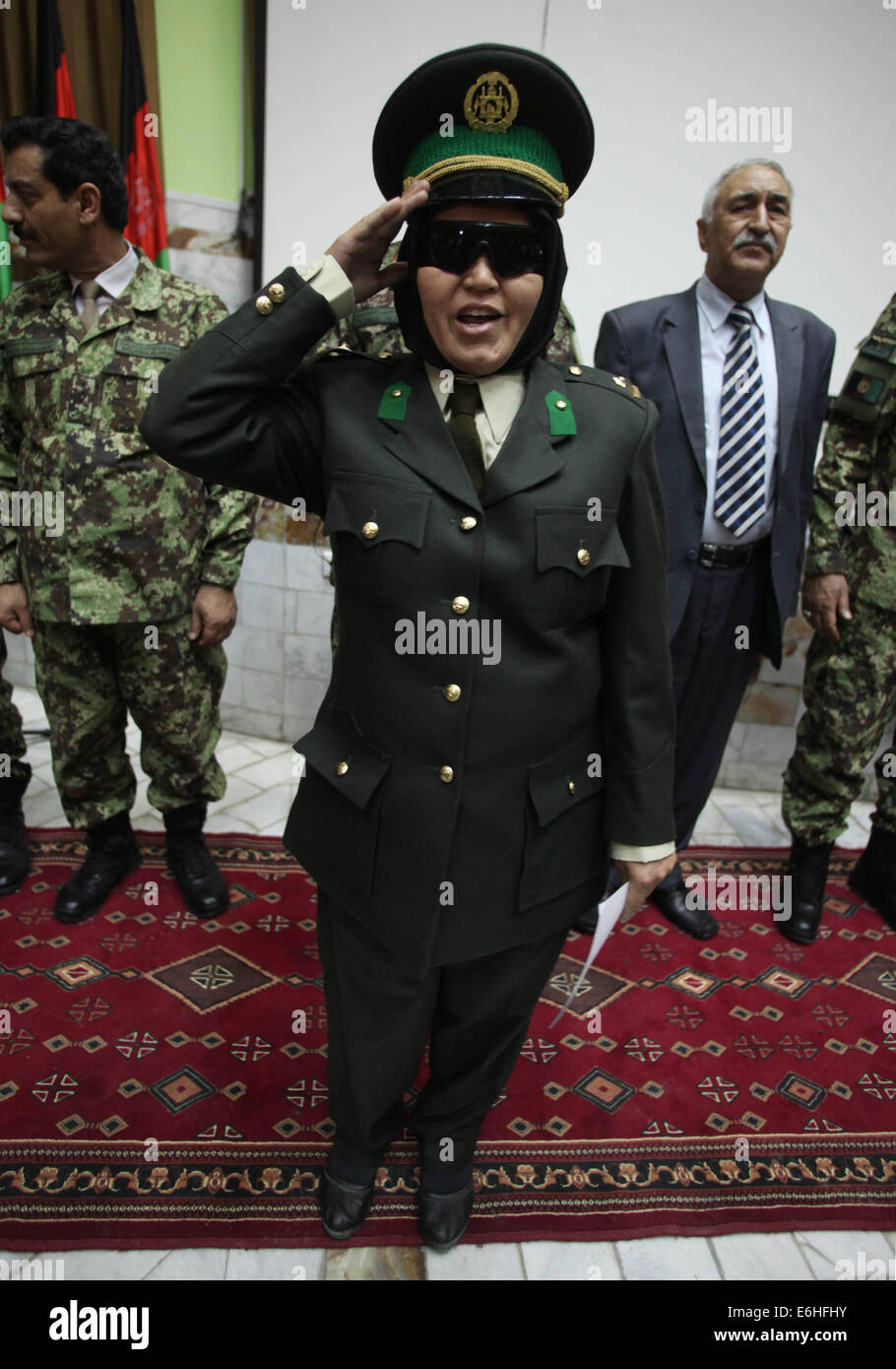 Kabul, Afghanistan. 24th Aug, 2014. A newly-graduated female Afghan National Army (ANA) officer salutes during the graduation ceremony in Kabul, Afghanistan on Aug. 24, 2014. A total of 30 female army officers graduated from Kabul Military Training Center (KMTC) on Sunday and commissioned to ANA, General Aminullah Paktiani commander of KMTC said. Credit:  Ahmad Massoud/Xinhua/Alamy Live News Stock Photo