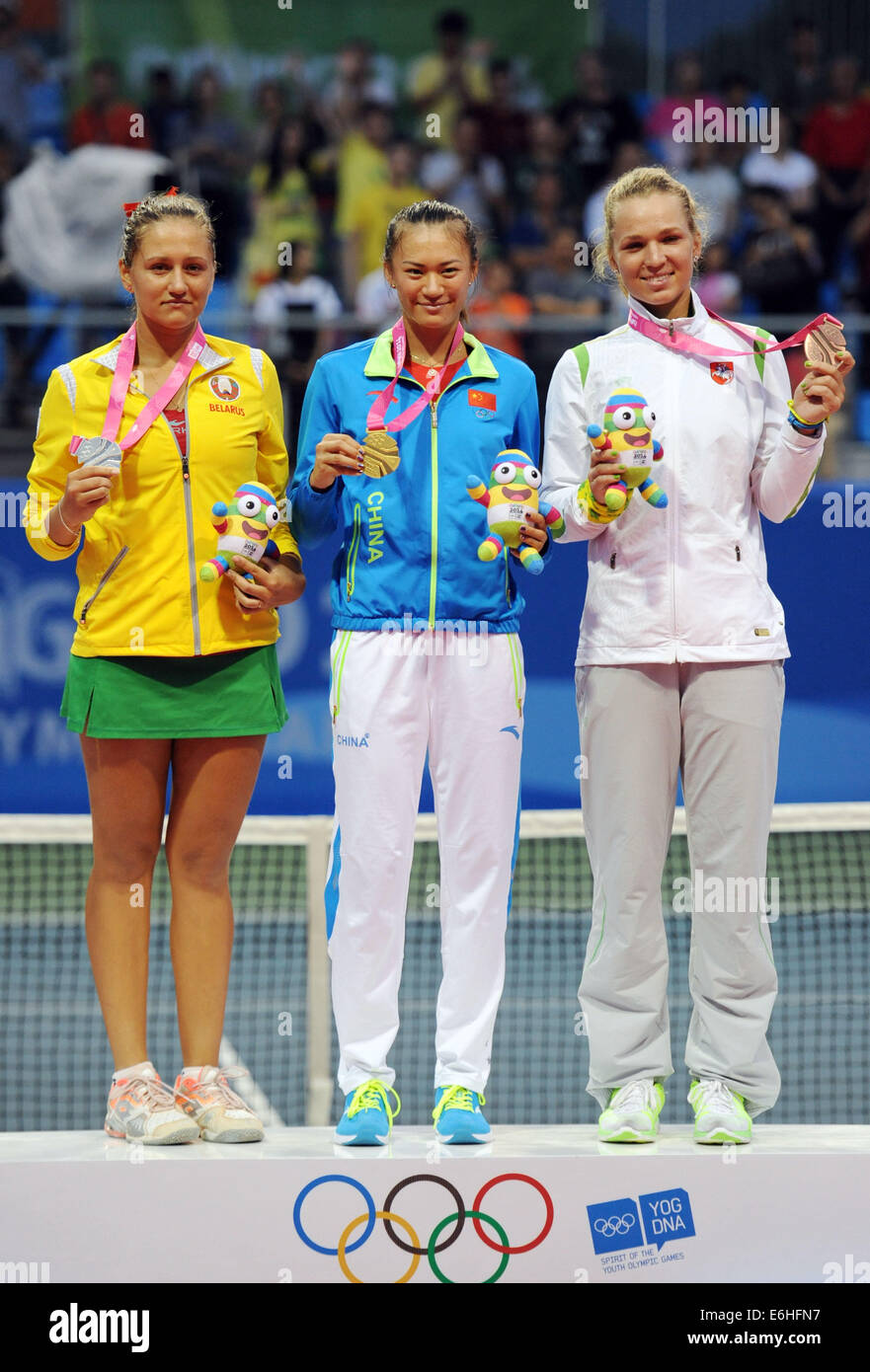 Nanjing, China's Jiangsu Province. 24th Aug, 2014. Gold medalist Xu Shilin of China(C), silver medalist Iryna Shymanovich of Belarus(L) and bronze medalist Akvile Parazinskaite of Lithuania pose on the podium during the awarding ceremony of the Women's Singles tennis match at Nanjing 2014 Youth Olympic Games in Nanjing, capital of east China's Jiangsu Province, on Aug. 24, 2014. Credit:  Chen Yehua/Xinhua/Alamy Live News Stock Photo