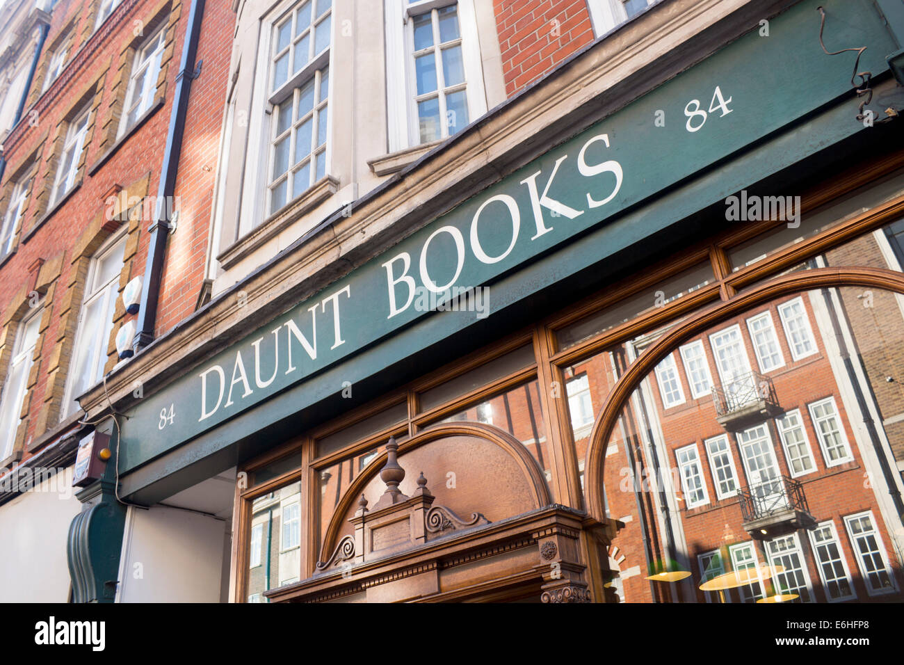 Daunt Books Independent travel bookshop Marylebone High Street London England UK Buildings opposite reflected in window Stock Photo