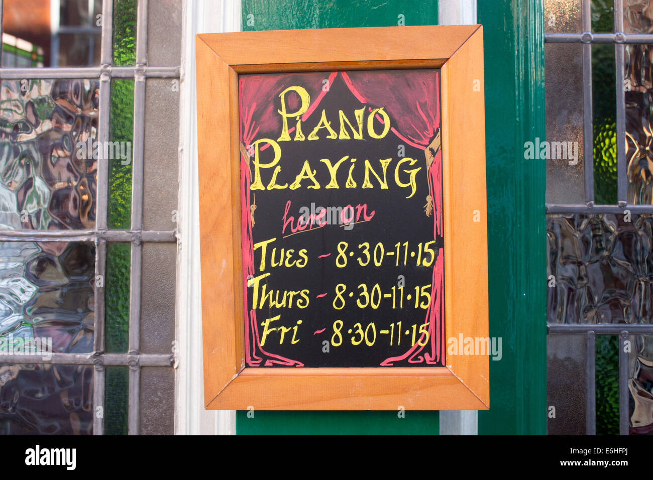 Piano playing sign on chalkboard blackboard outside pub London England UK Stock Photo