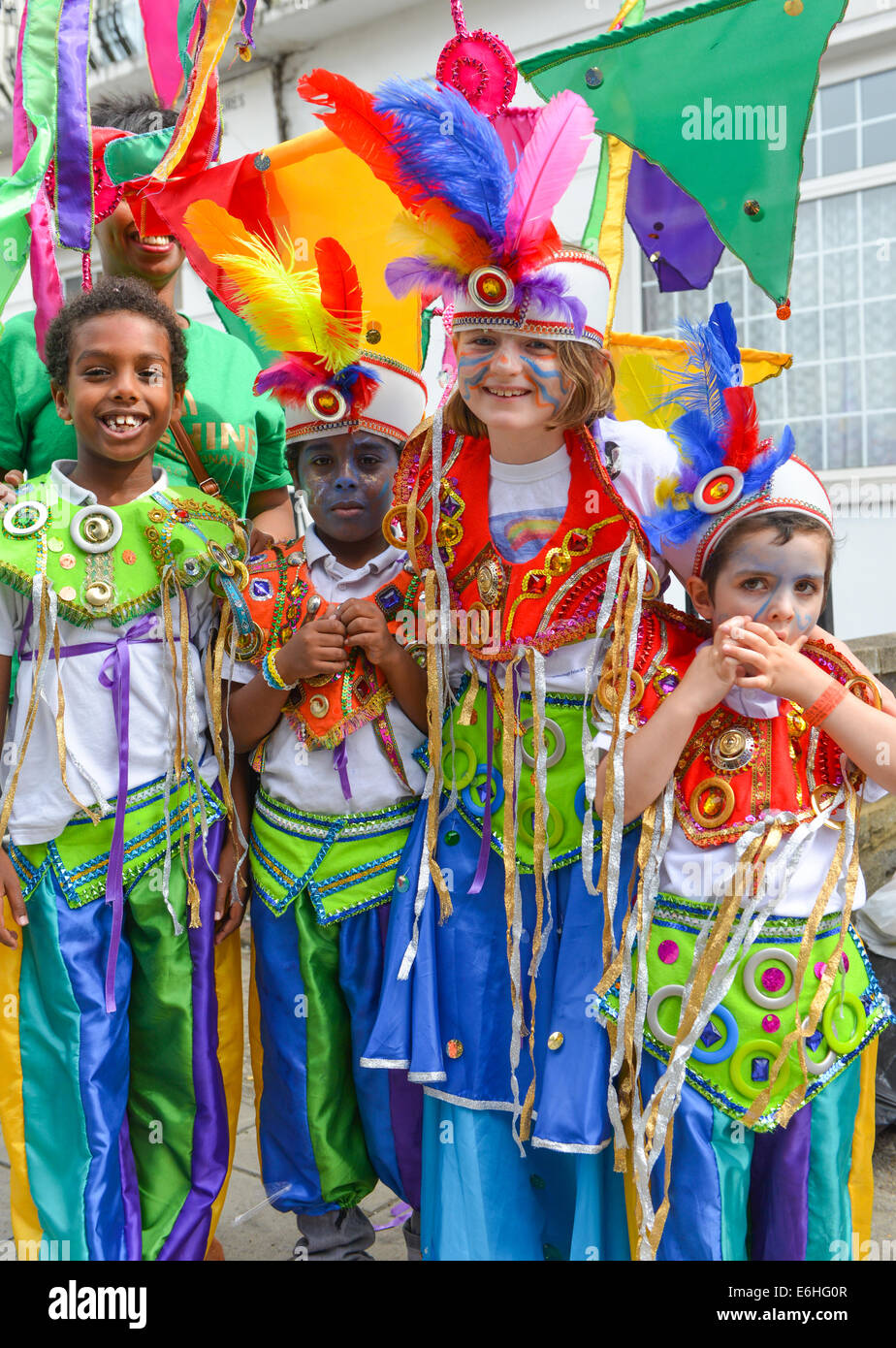 Notting Hill, London, UK. 24th August 2014. Four children in costume at the  parade. Sunday is Children's Day at the Notting Hill Carnival of Carribean  culture of music, dancing, food and drink.