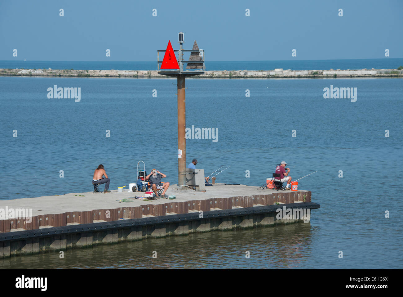 Ohio, Lake Erie, Cleveland. Cleveland Harbor, fishermen on the pier. Stock Photo