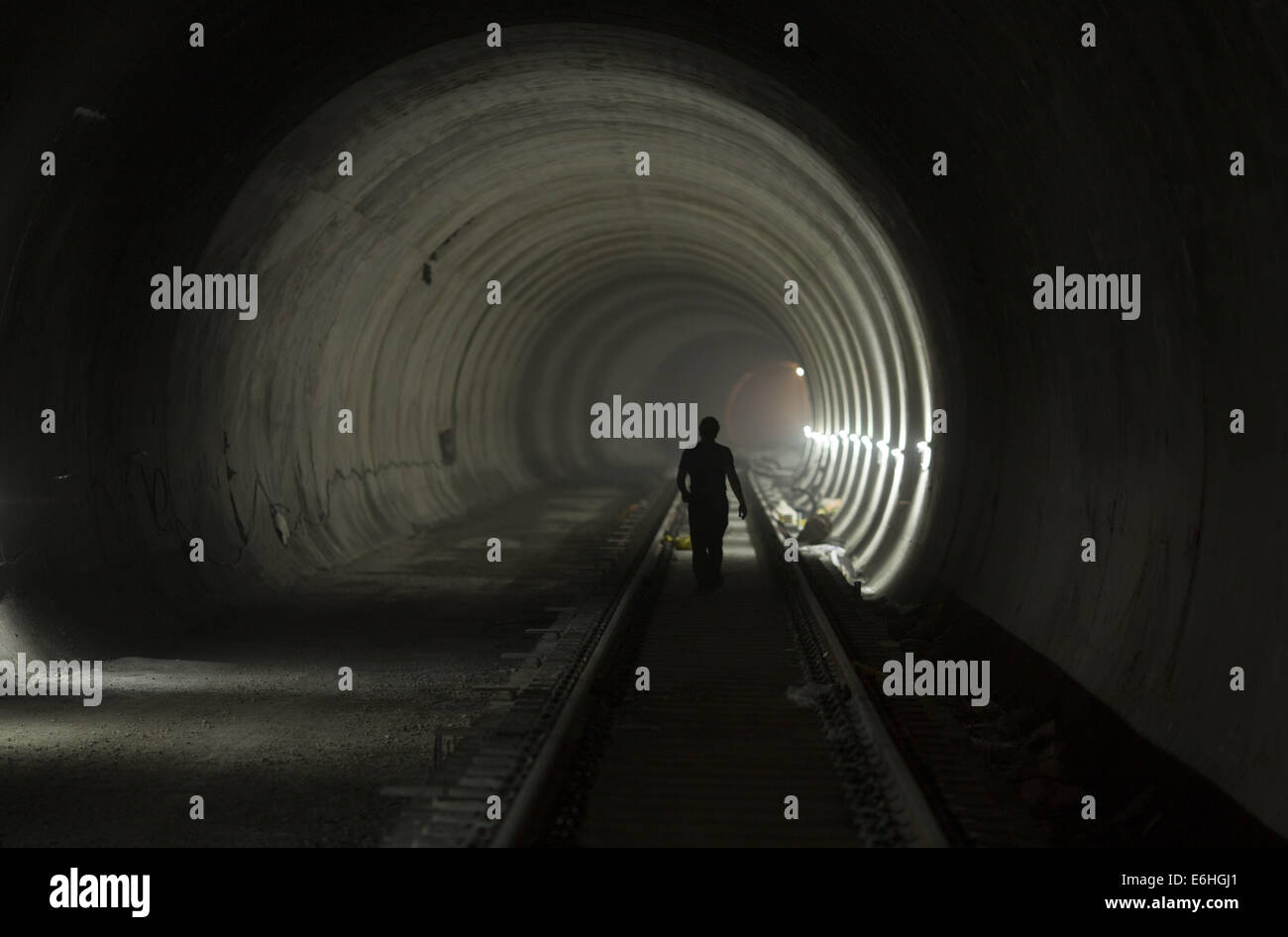 August 24, 2014 - Tehran, Iran - An Iranian worker walks along a tunnel of the northern part of Tehran's Subway Line 3. Subway line 3 with 37 km (23 miles) long and 28 stations will be the main public transportation and connection between southwest and northeast of Tehran.  (Credit Image: © Morteza Nikoubazl/ZUMA Wire) Stock Photo