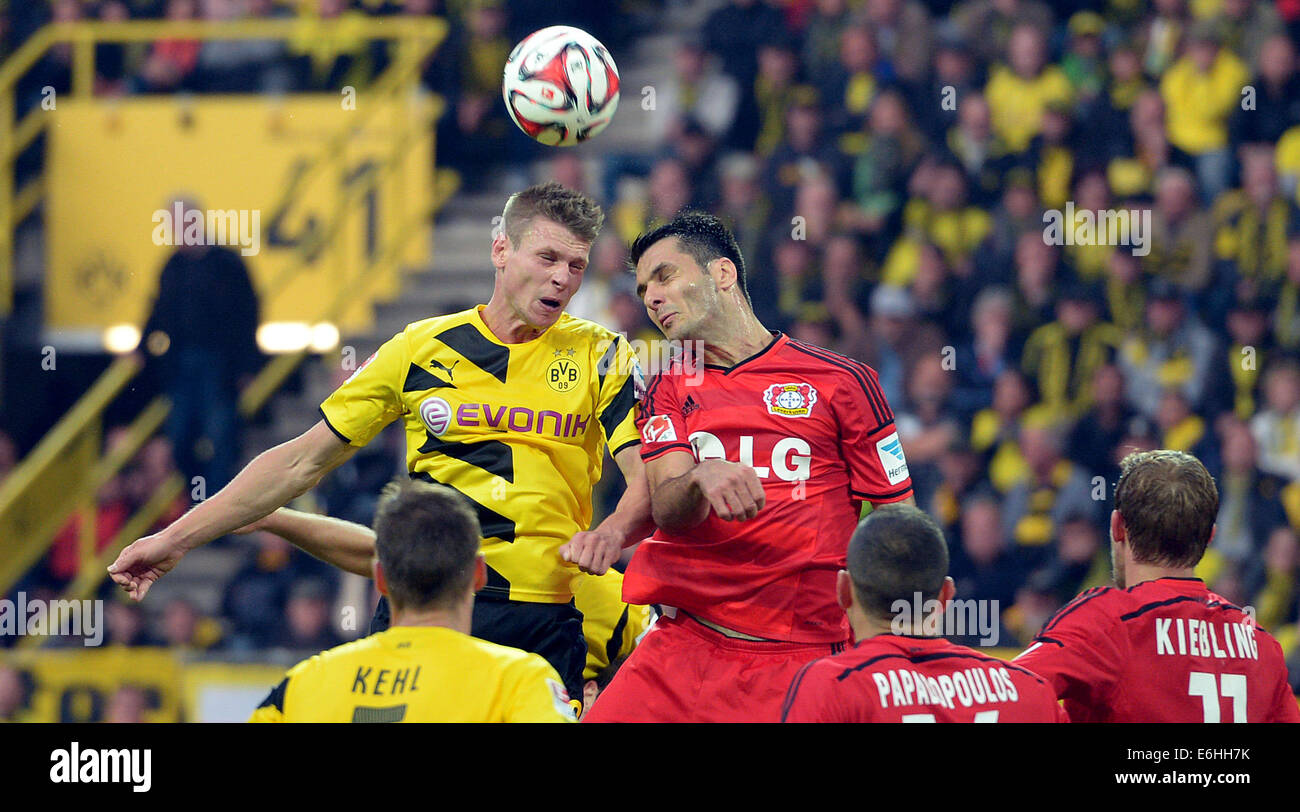 Dortmund's Lukasz Piszczek (L) and  Leverkusen's Emir Spahic vie for the ball during the German Bundesliga soccer match between Borussia Dortmund and Bayer 04 Leverkusen at Signal-Iduna-Park in Dortmund, Germany, 23 August 2014. Stock Photo