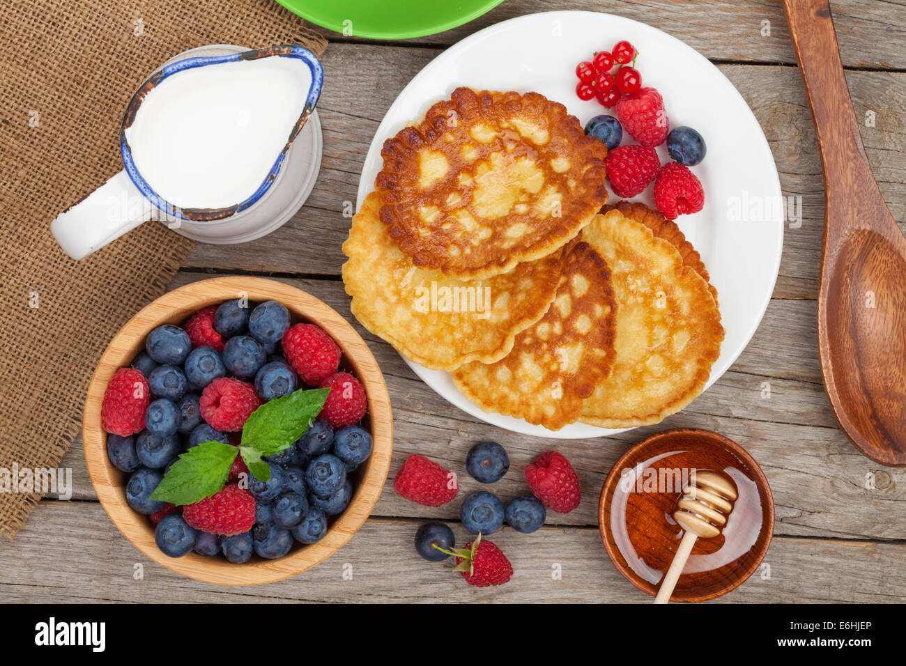 Pancakes Raspberry Blueberries Mint Pancakes with raspberry, blueberry, mint and honey syrup. On wooden ...
