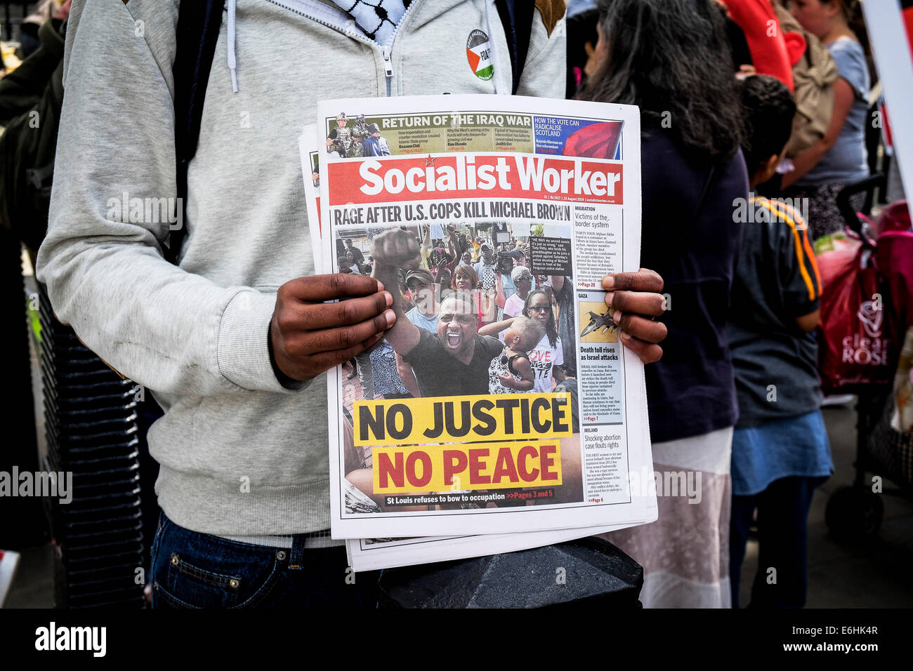 A person holding a copy of the Socialist Worker newspaper. Stock Photo