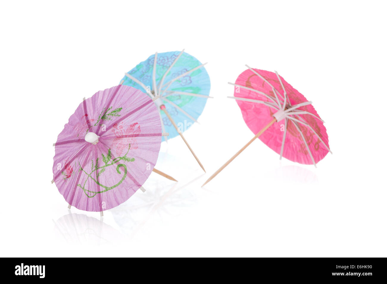 Three colored cocktail umbrellas. Isolated on white background Stock Photo